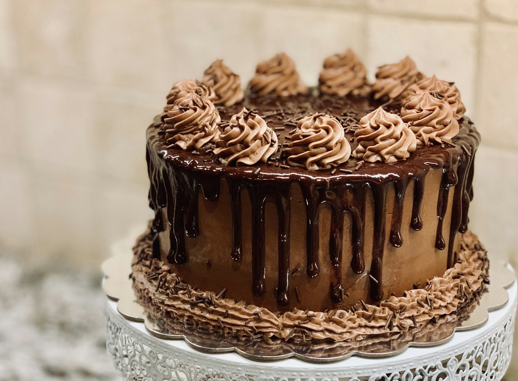 Chocolate cake with glossy chocolate frosting, illustrative photography
